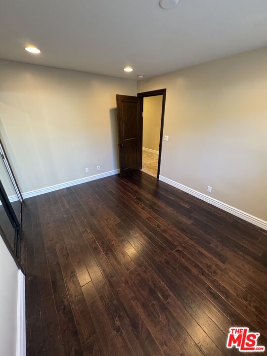 5515 Ruthwood Drive Calabasas, CA 91302 - Photo 27 of 48 a view of an empty room with wooden floor and a window