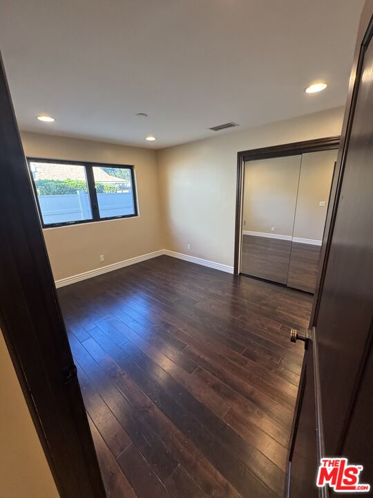 5515 Ruthwood Drive Calabasas, CA 91302 - Photo 28 of 48 an empty room with wooden floor and windows