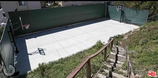 a view of an empty room with a fireplace and a window