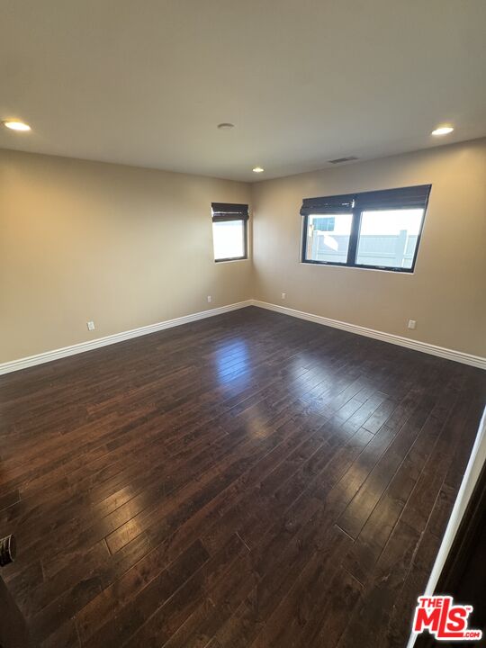 5515 Ruthwood Drive Calabasas, CA 91302 - Photo 31 of 48 an empty room with wooden floor and windows
