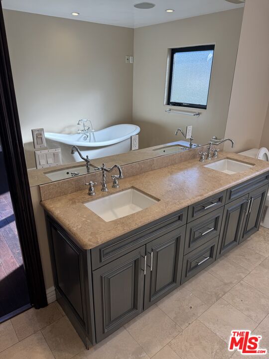 5515 Ruthwood Drive Calabasas, CA 91302 - Photo 45 of 48 a sink and a mirror