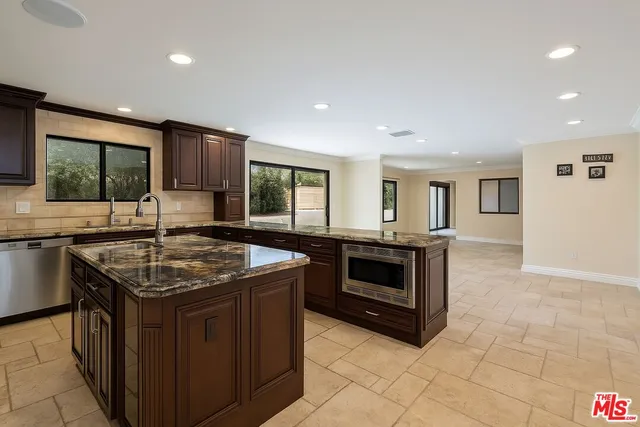 a view of an empty room with window and an empty room