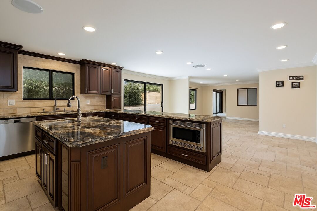 5515 Ruthwood Drive Calabasas, CA 91302 - Photo 6 of 48 a kitchen with stainless steel appliances granite countertop a stove and a sink
