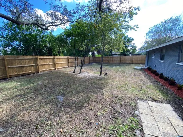 a backyard of a house with lots of green space