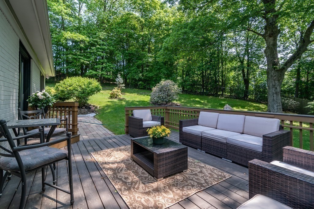 10 Winch Way Natick, MA 01760 - Photo 13 of 34 a view of a patio with couches and a table and chairs with wooden floor and fence