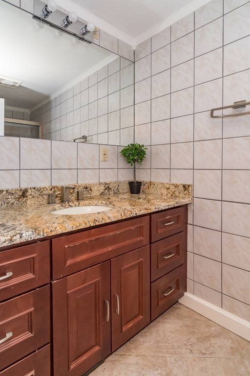 10 Winch Way Natick, MA 01760 - Photo 23 of 34 a bathroom with a granite countertop sink and a mirror