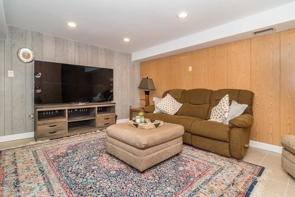 10 Winch Way Natick, MA 01760 - Photo 24 of 34 a living room with furniture and a flat screen tv