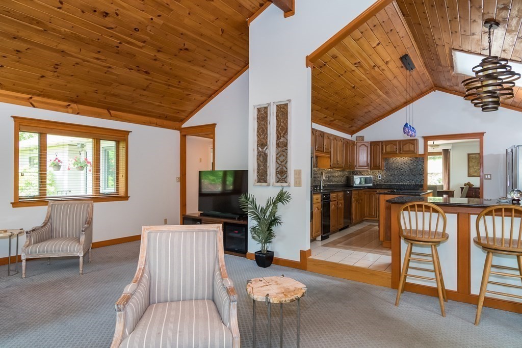 10 Winch Way Natick, MA 01760 - Photo 5 of 34 a living room with furniture a fireplace and a table