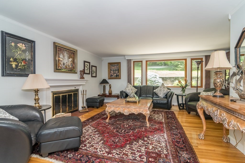 10 Winch Way Natick, MA 01760 - Photo 10 of 34 a living room with furniture fireplace and a large window