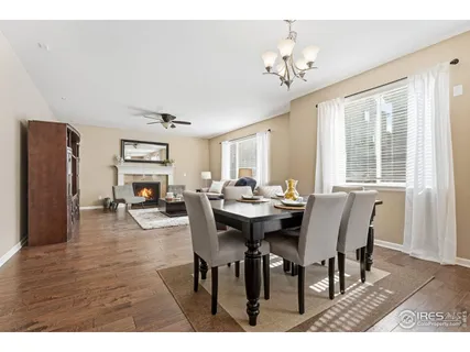 a view of a dining room with furniture a chandelier and wooden floor