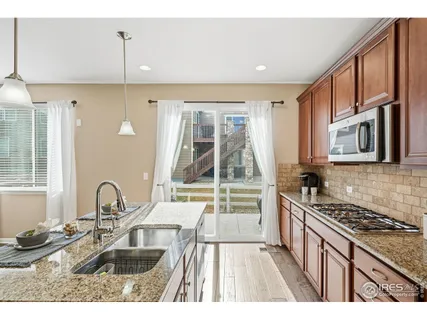 a kitchen with sink a stove and a microwave