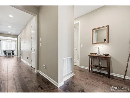 a hallway with wooden floor and furniture