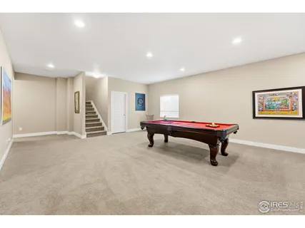 a room with furniture and pool tables