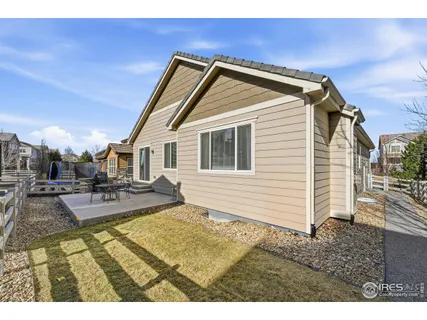 a view of a house with backyard porch and sitting area