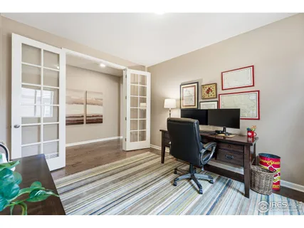 a view of a workspace with furniture and a window