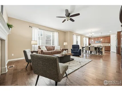 a living room with furniture a wooden floor and chandelier