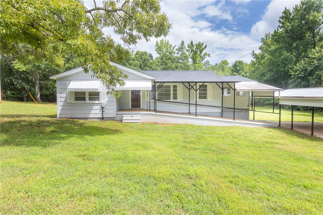 1317 East Broad Street Iva, SC 29655 - Photo 1 of 29 A welcoming front exterior offers a ramp for easy access, complemented by a covered carport for convenience.