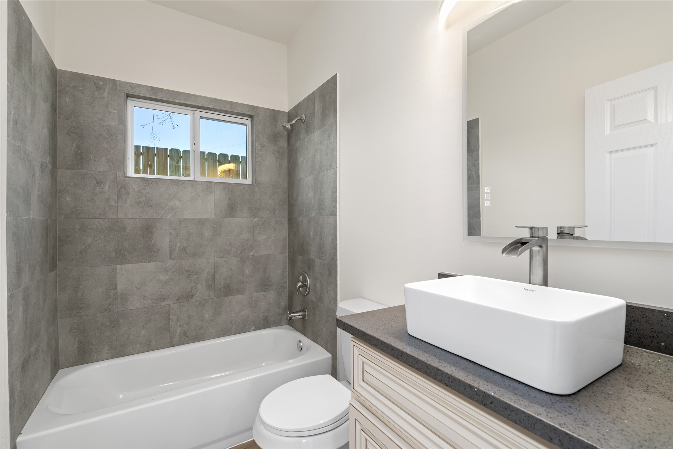 4656 North Teague Street Rosharon, TX 77583 - Photo 33 of 41 Full bathroom featuring tub/shower combo with elegant tile surround and modern vanity.