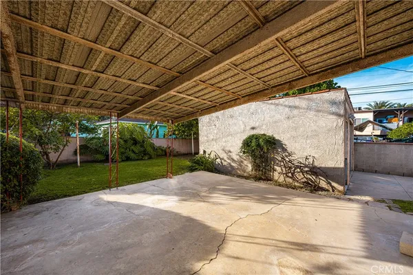 a view of a backyard with plants and patio