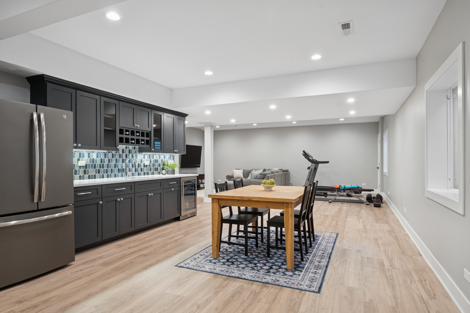 928 Hunter Road Glenview, IL 60025 - Photo 30 of 40 a kitchen with stainless steel appliances granite countertop a dining table chairs refrigerator and cabinets