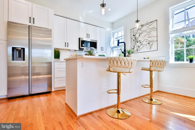 a kitchen with stainless steel appliances a refrigerator and a window