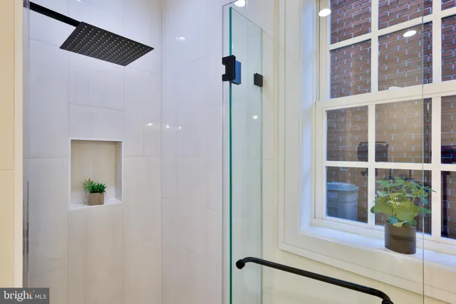 a view of a room with wooden floor and white walls
