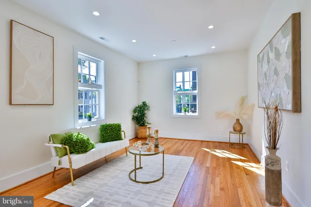 a living room with stainless steel appliances kitchen island granite countertop furniture a rug a fireplace and a kitchen view