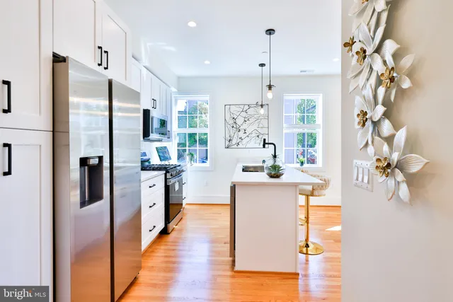 a kitchen with kitchen island a counter top space and wooden floor