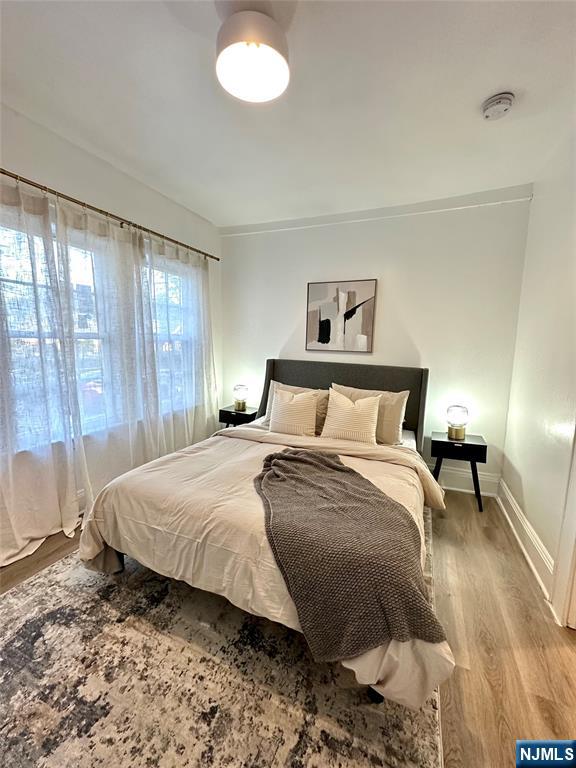 48 Maple Avenue, Unit 2 Montclair, NJ 07042 - Photo 3 of 7 a bedroom with a bed and a lamp