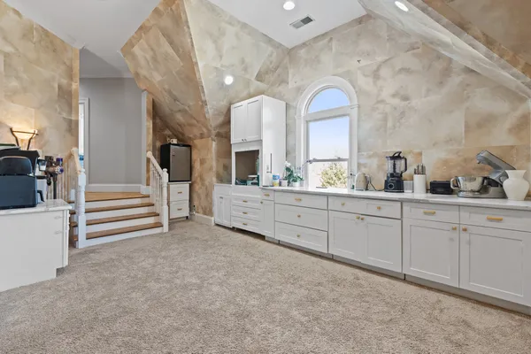 a bathroom with a sink a vanity and a painting on the wall