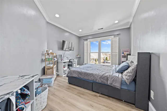 a bedroom with a bed and a large window