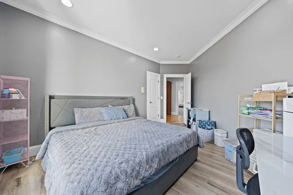 a bedroom with a bed and a large window