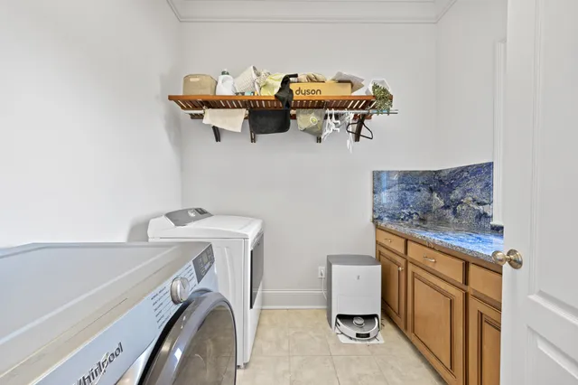 a kitchen with stainless steel appliances granite countertop a sink stove oven and white cabinets with wooden floor