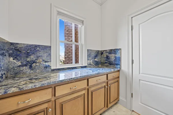 a kitchen with stainless steel appliances granite countertop a sink stove oven and white cabinets with wooden floor
