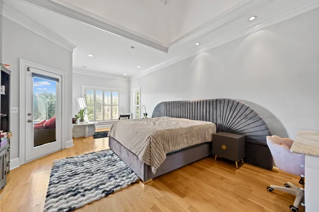 a view of a dining room with furniture one side kitchen view and wooden floor
