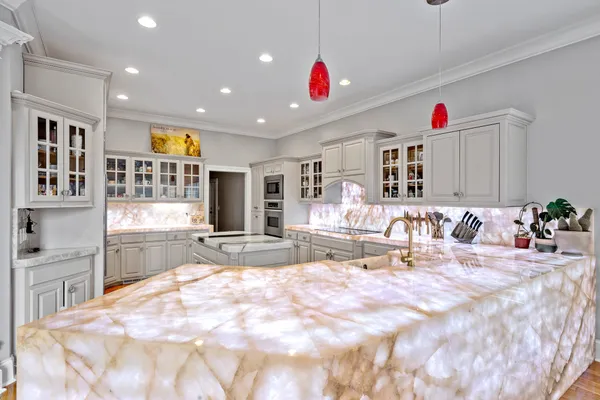 a kitchen with stainless steel appliances granite countertop a sink and a stove