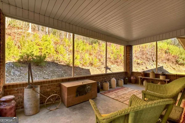 a bedroom with furniture and large windows