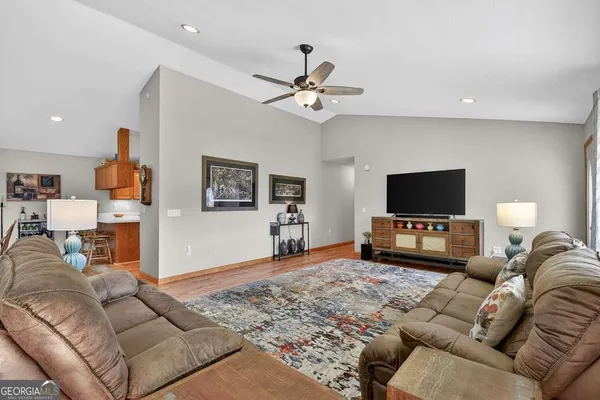 a living room with furniture and a flat screen tv