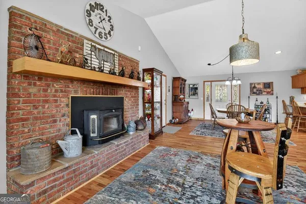 a living room with furniture a fireplace and a chandelier