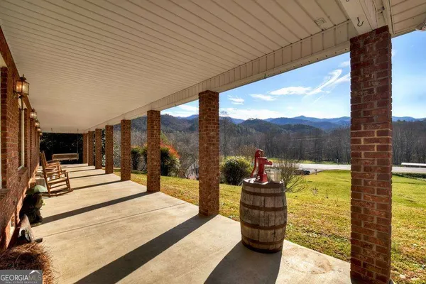 a building outdoor space with patio furniture and garden view