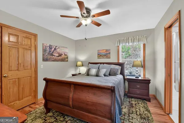 a bedroom with a bed and a painting on the wall