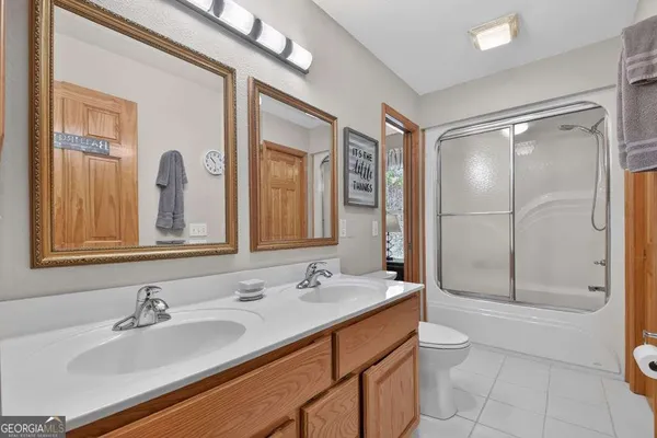 a bathroom with a double vanity sink mirror and toilet