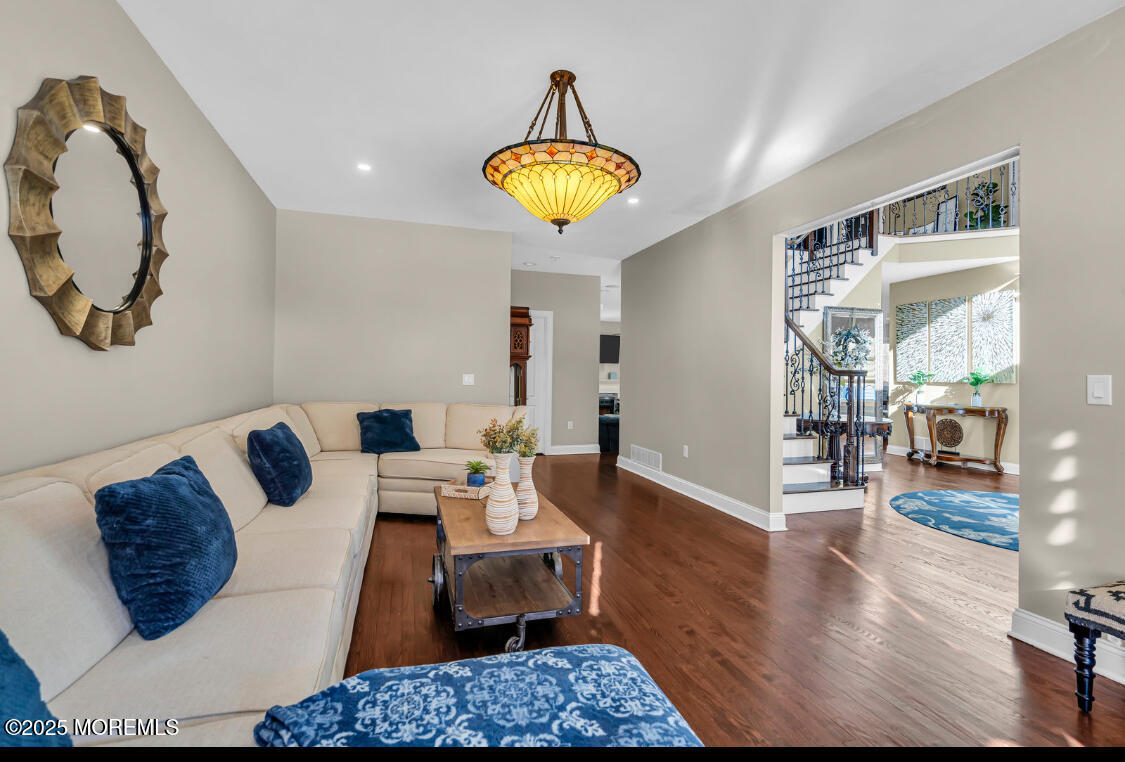 9 Mehar Court Jackson, NJ 08527 - Photo 12 of 40 a living room with furniture and a chandelier