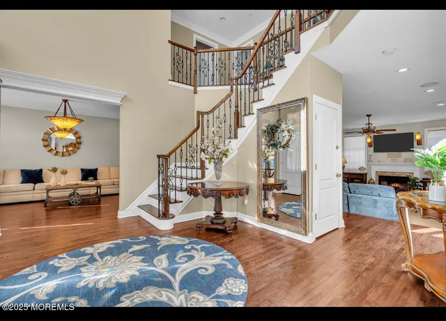 a view of a livingroom with furniture a flat screen tv and couches