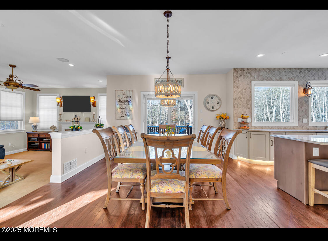 9 Mehar Court Jackson, NJ 08527 - Photo 2 of 40 a dining room with furniture a chandelier and wooden floor