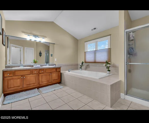 a bathroom with a sink mirror and a bathtub