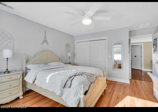 a bedroom with a bed and closet with view