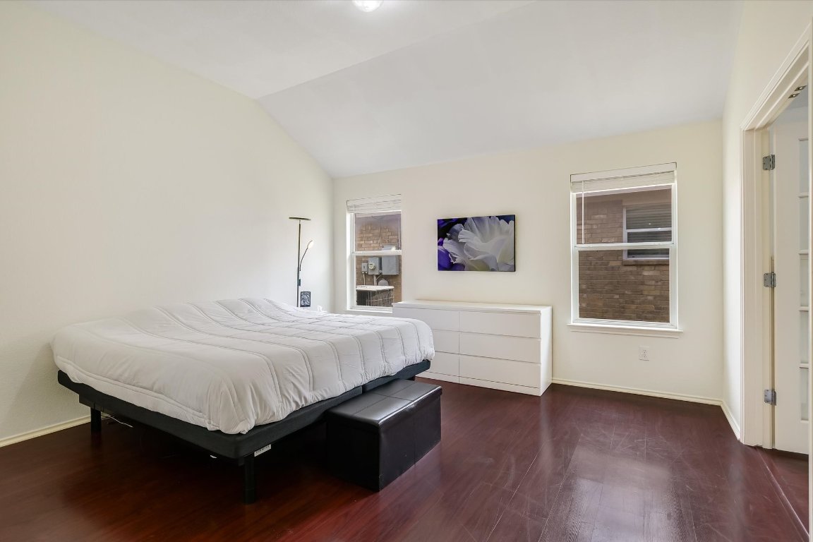 1901 Rachel Lane Round Rock, TX 78664 - Photo 25 of 35 Bedroom with vaulted ceiling, wood finished floors, and baseboards