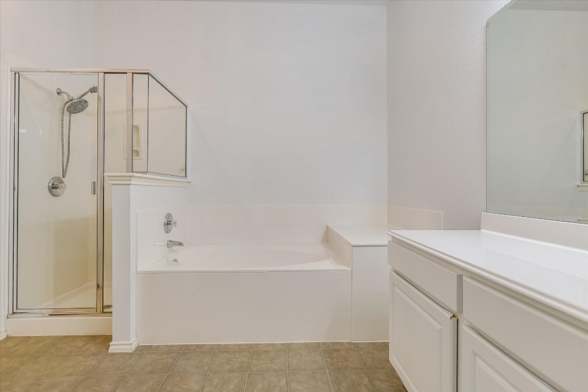 1901 Rachel Lane Round Rock, TX 78664 - Photo 27 of 35 Full bath with tile patterned flooring, a garden tub, vanity, and a stall shower