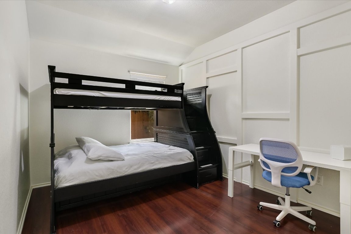 1901 Rachel Lane Round Rock, TX 78664 - Photo 29 of 35 Bedroom featuring baseboards, vaulted ceiling, and dark wood-style floors